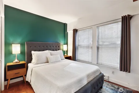 a bedroom with a bed and a window