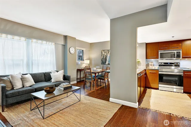 a living room with furniture and a wooden floor
