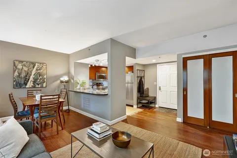 a living room with furniture and wooden floor