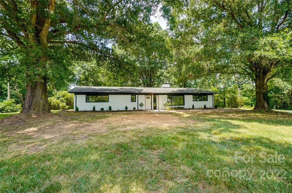 3001 Morgan Mill Road Monroe, NC 28110 - Photo 3 of 36 a view of a house with a yard and large trees