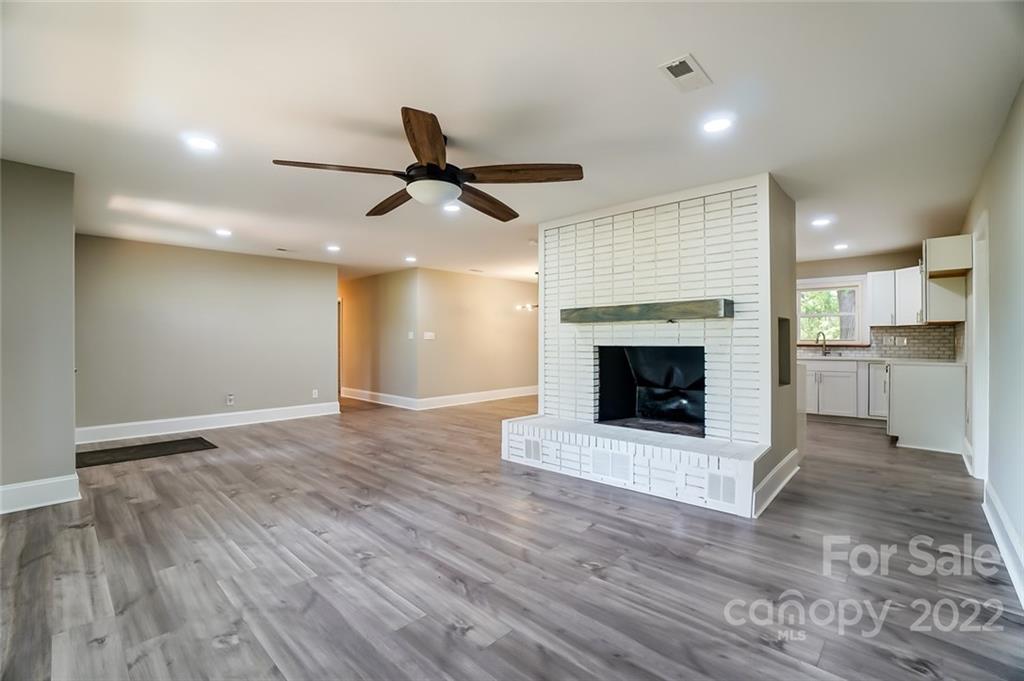 3001 Morgan Mill Road Monroe, NC 28110 - Photo 7 of 36 a view of a kitchen with a fireplace and wooden floor