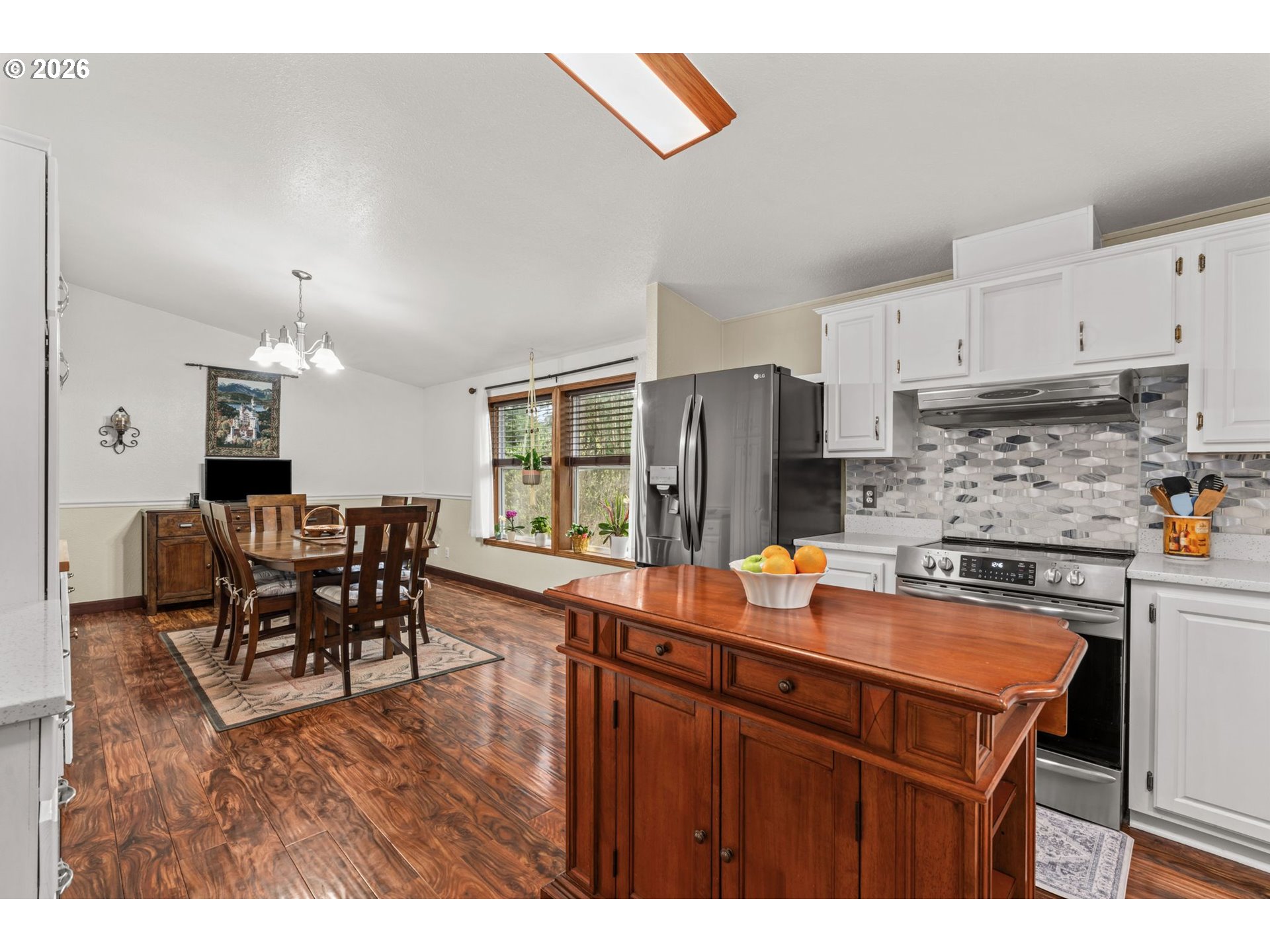 49400 Eagle Rock Place Vida, OR 97488 - Photo 11 of 48 a kitchen with stainless steel appliances granite countertop a table chairs and a refrigerator