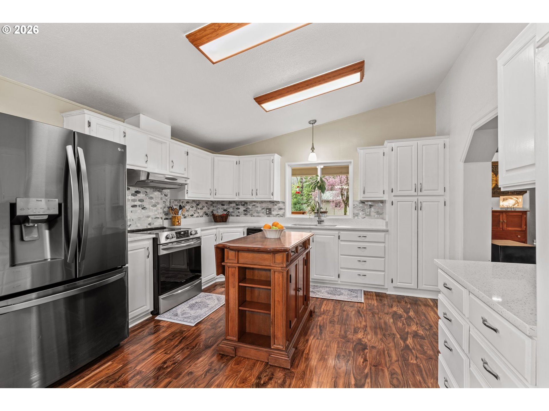 49400 Eagle Rock Place Vida, OR 97488 - Photo 12 of 48 a kitchen with stainless steel appliances kitchen island granite countertop a refrigerator a stove a sink and a white cabinets