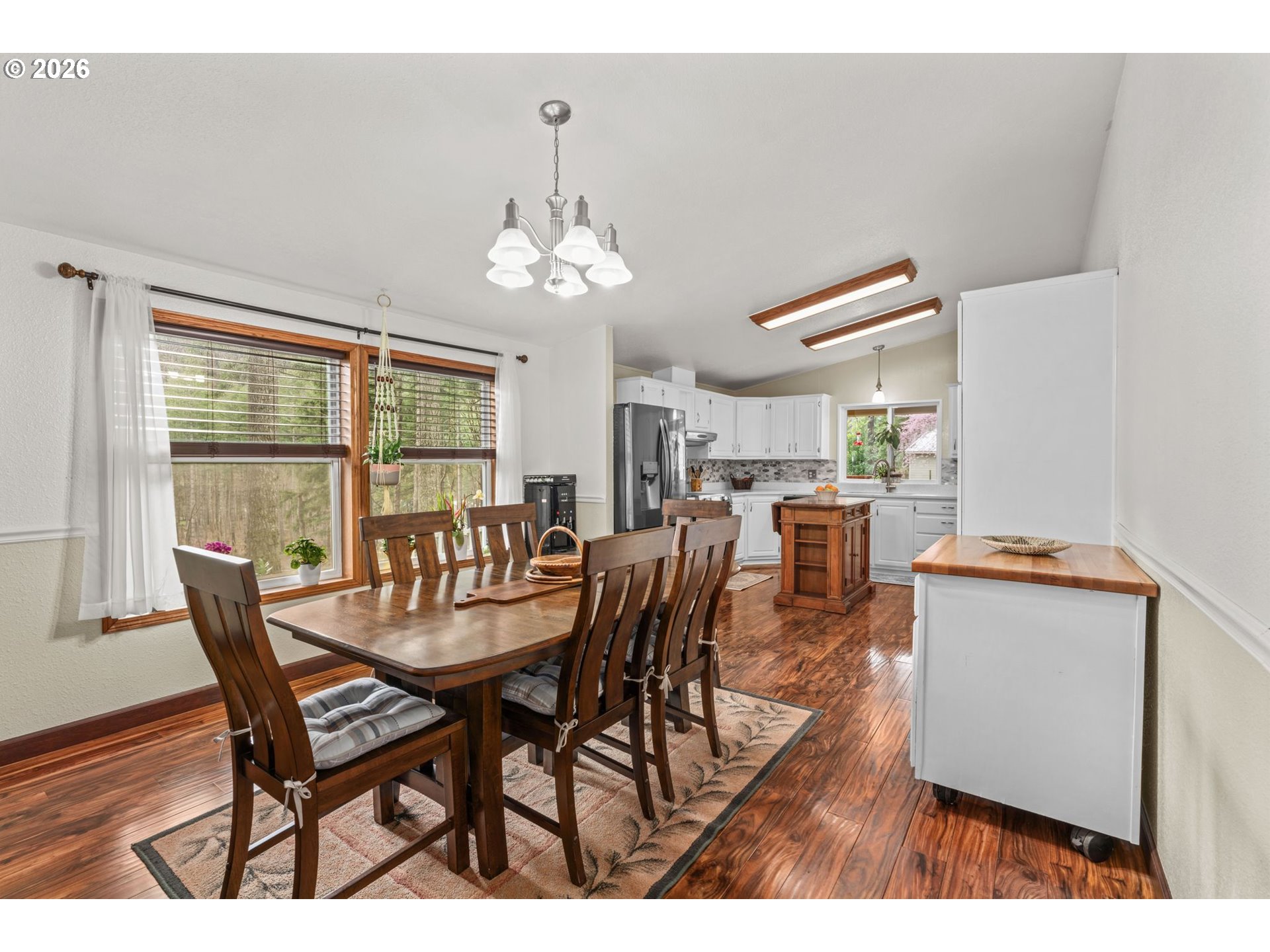 49400 Eagle Rock Place Vida, OR 97488 - Photo 14 of 48 a dining room with furniture a chandelier and wooden floor