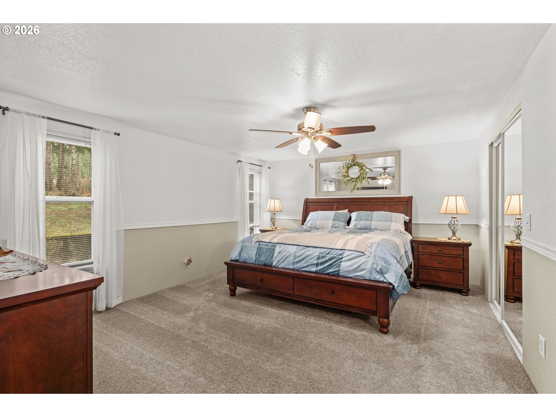 49400 Eagle Rock Place Vida, OR 97488 - Photo 16 of 48 a spacious bedroom with a bed and a chandelier