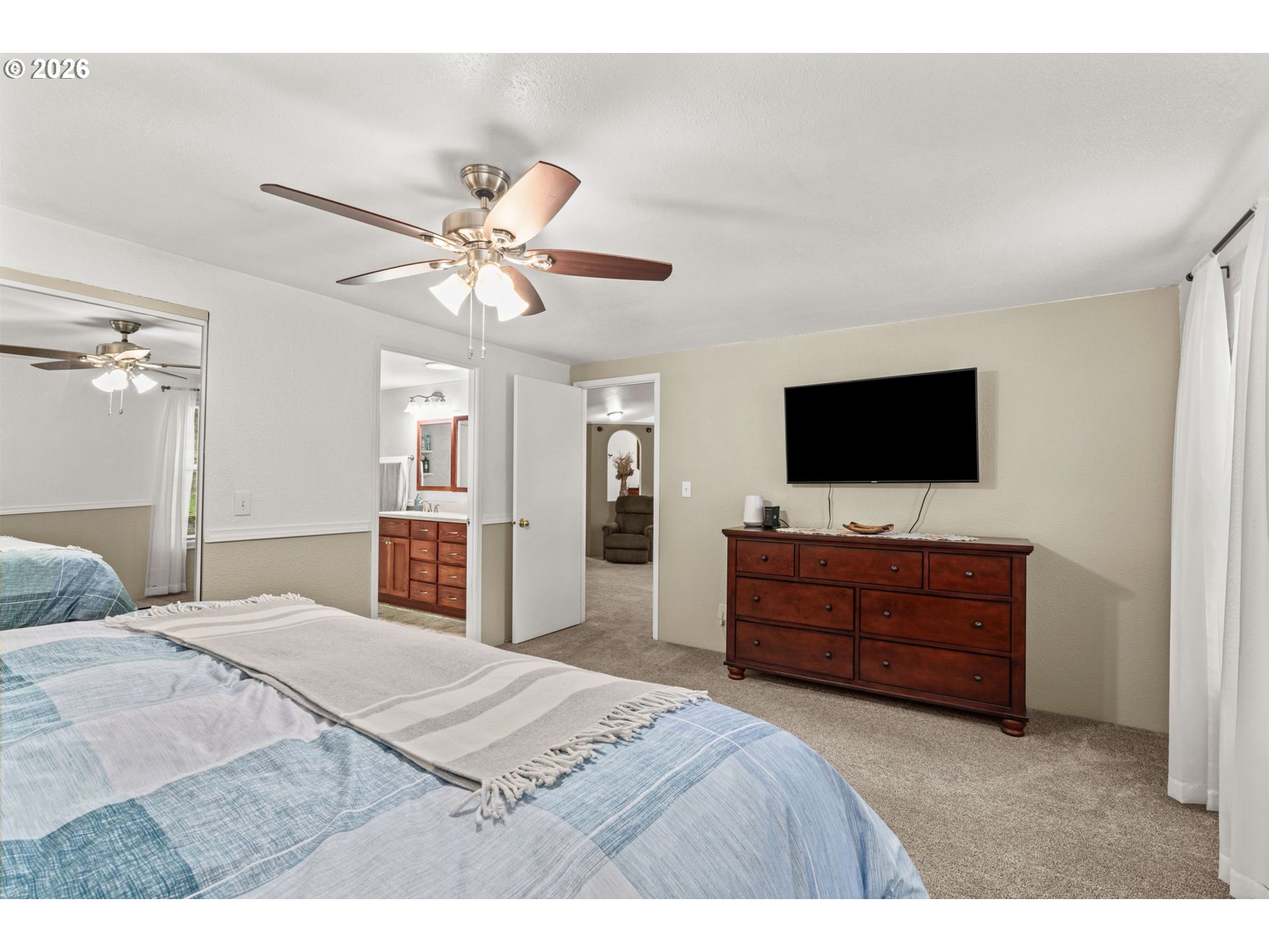 49400 Eagle Rock Place Vida, OR 97488 - Photo 18 of 48 a bedroom with a bed flat screen tv and a dresser