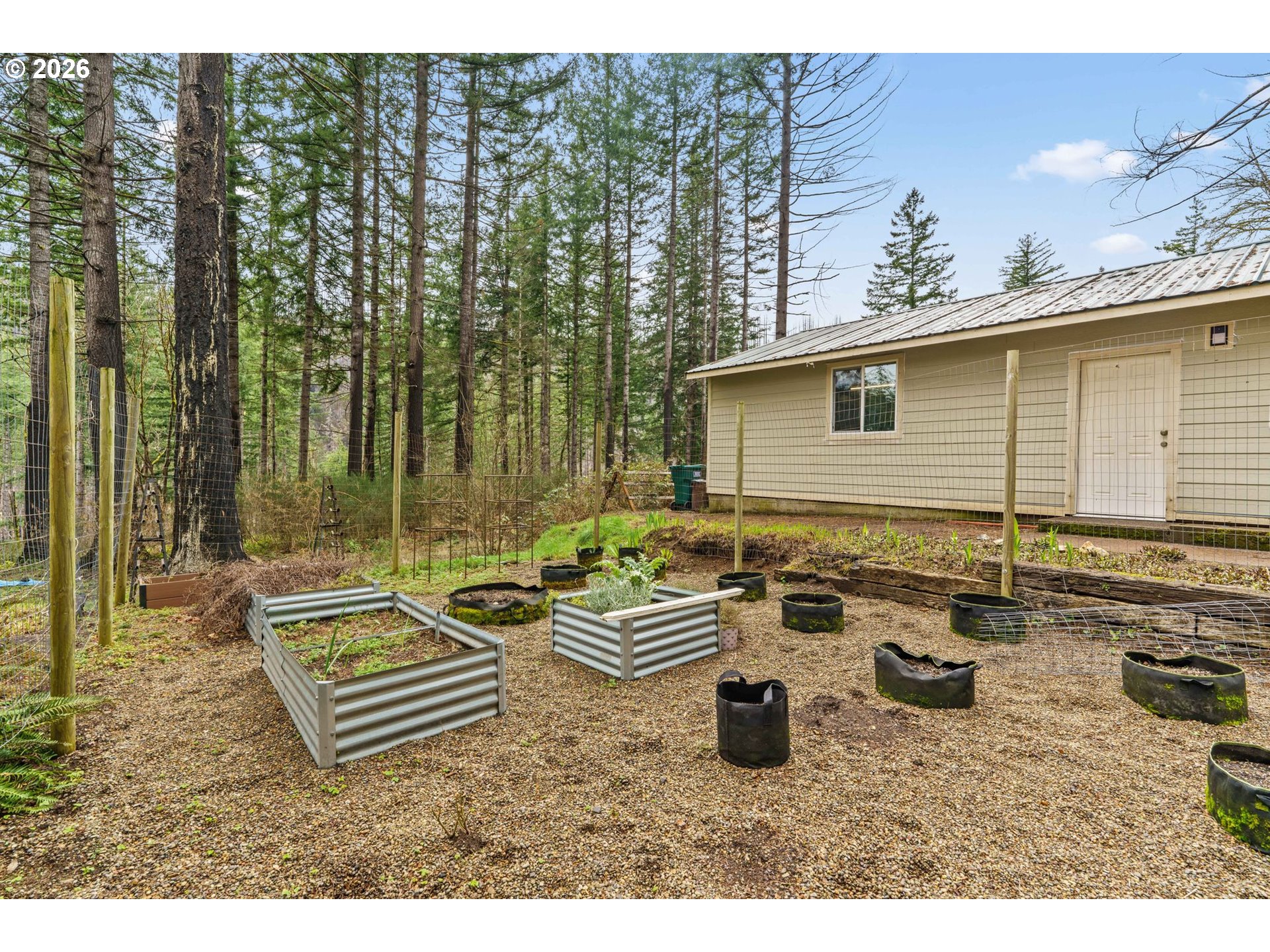 49400 Eagle Rock Place Vida, OR 97488 - Photo 32 of 48 a backyard of a house with barbeque oven table and chairs