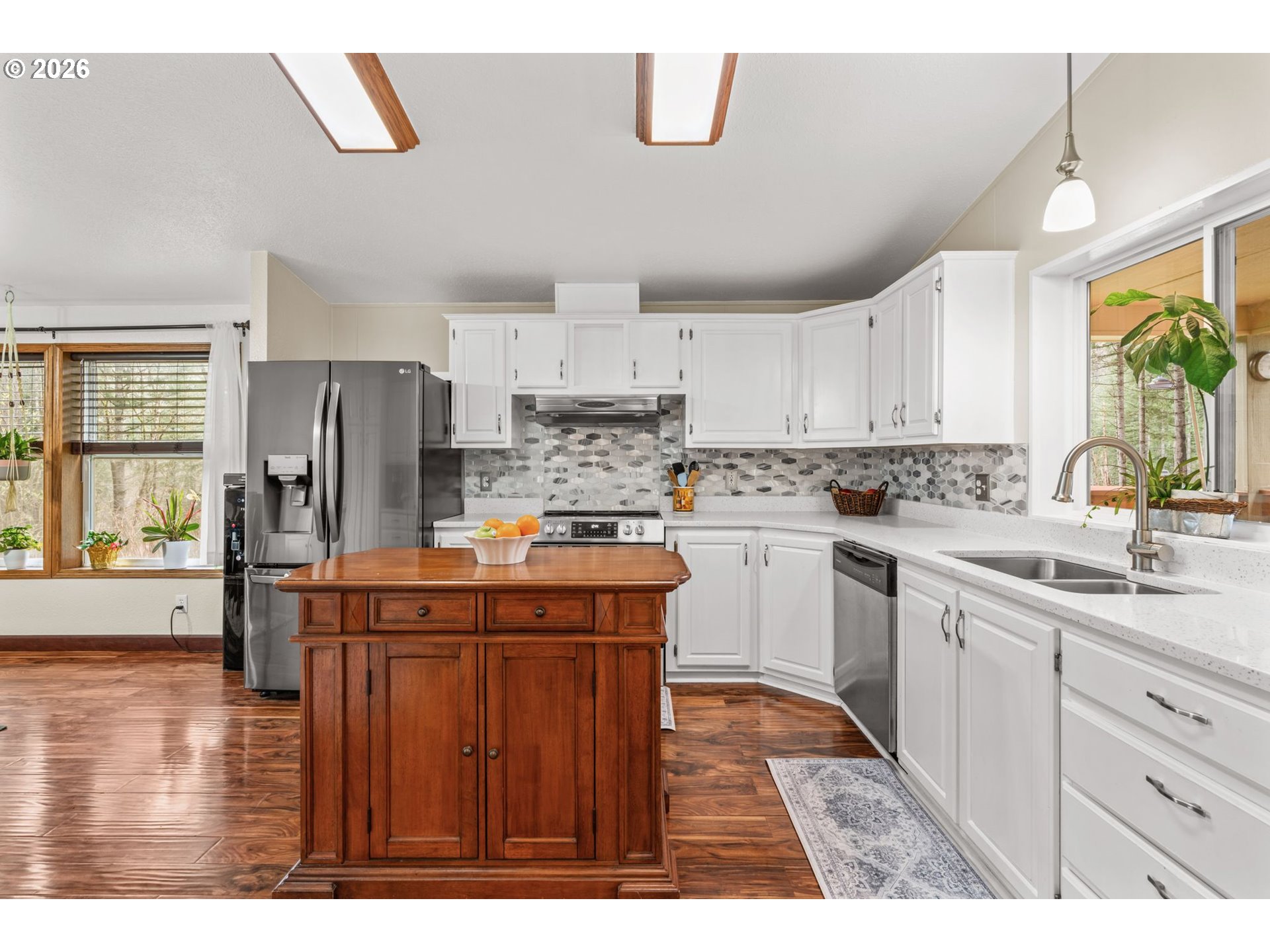 49400 Eagle Rock Place Vida, OR 97488 - Photo 9 of 48 a kitchen with kitchen island granite countertop a sink appliances cabinets and a counter top space