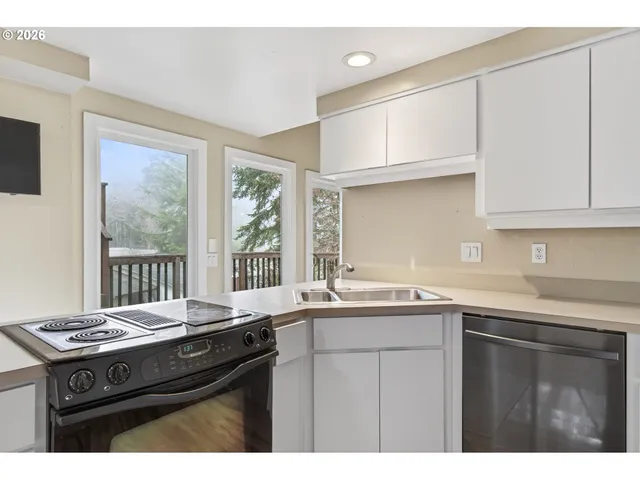 a kitchen with a sink stove and cabinets