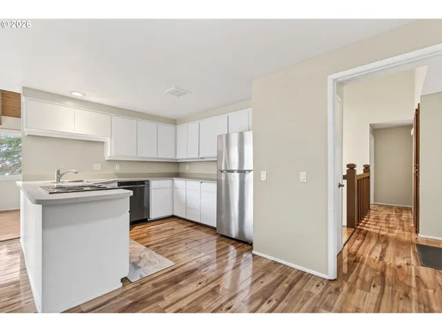 a kitchen with a refrigerator and a sink