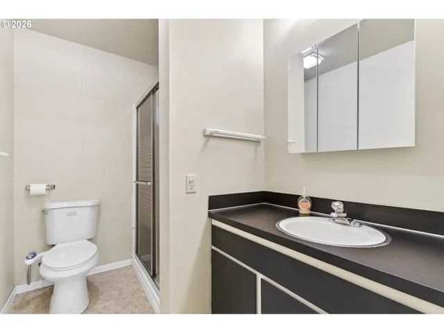 a bathroom with a sink toilet and a mirror