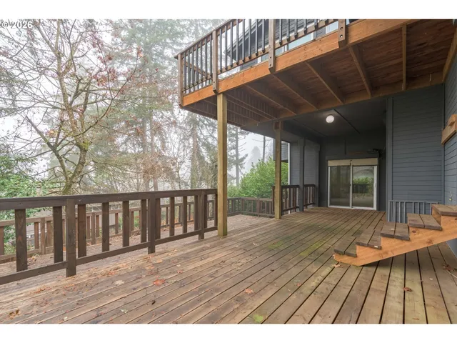 a view of backyard with a deck and wooden floor