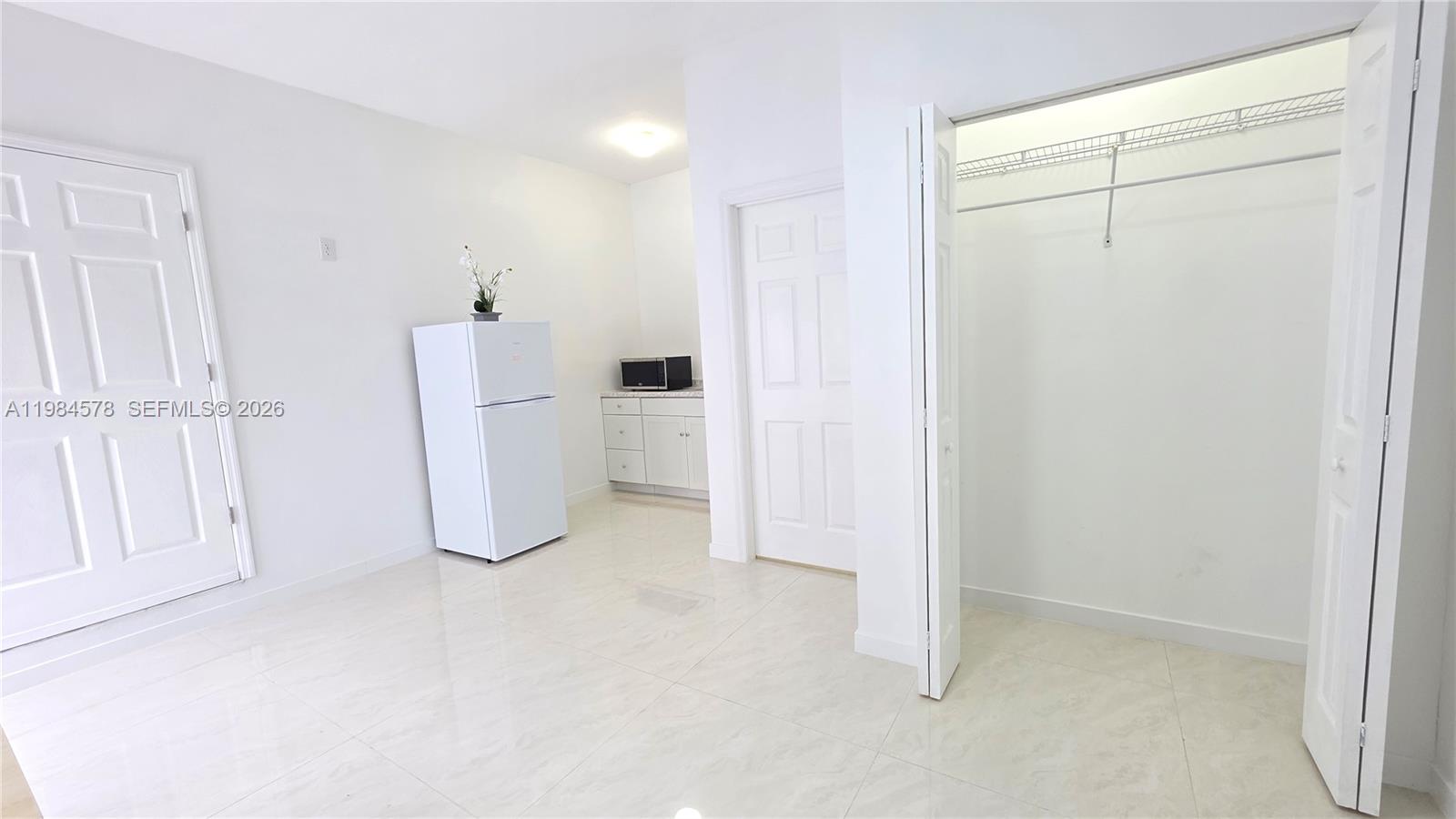 14552 Southwest 158th Court Miami, FL 33196 - Photo 15 of 21 a view of a storage & utility room with refrigerator