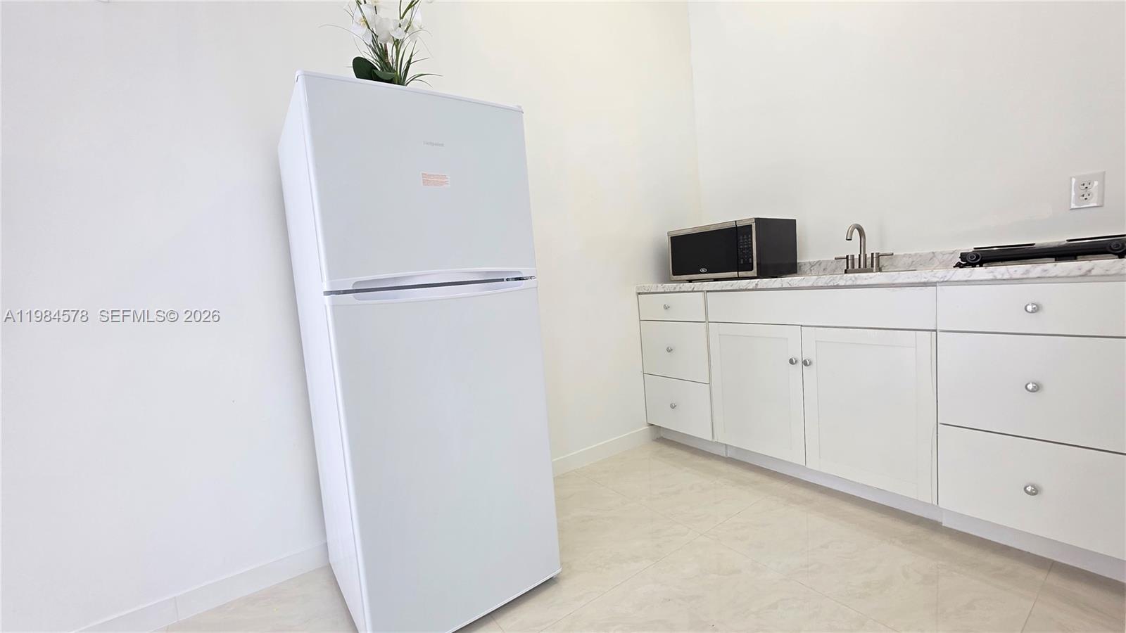 14552 Southwest 158th Court Miami, FL 33196 - Photo 16 of 21 a white refrigerator freezer sitting inside of a kitchen