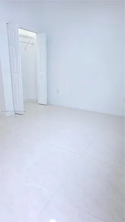 a white toilet sitting next to a white sink a shower curtain