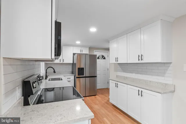 a kitchen with refrigerator and cabinets