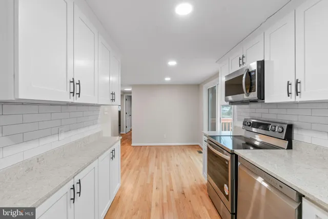 a kitchen with a sink a microwave and cabinets