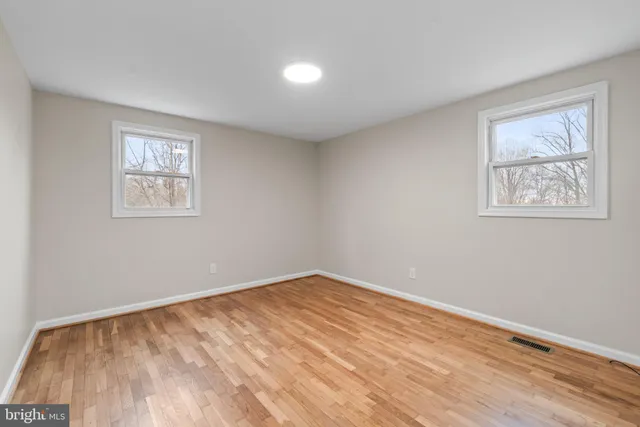 a view of room with window and hardwood floor