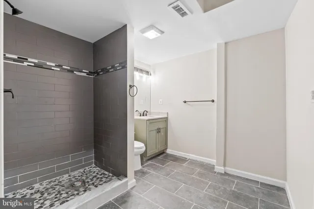 a bathroom with a shower and a sink