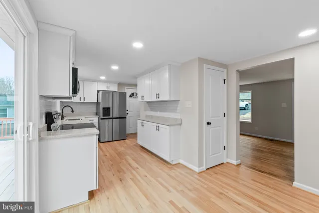 a kitchen with stainless steel appliances a refrigerator and a stove top oven