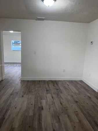 a view of an empty room and wooden floor