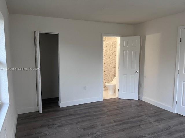 21221 Southwest 120th Avenue Miami, FL 33177 - Photo 19 of 38 a view of an empty room with wooden floor and closet