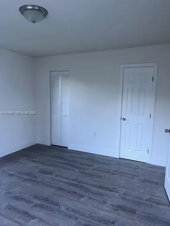 a view of an empty room and wooden floor