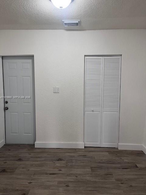 21221 Southwest 120th Avenue Miami, FL 33177 - Photo 5 of 38 a view of an empty room with wooden floor