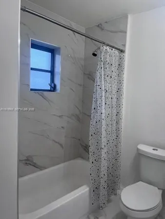a bathroom with a toilet and a bathtub