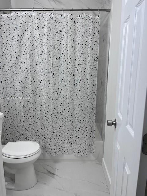 21221 Southwest 120th Avenue Miami, FL 33177 - Photo 8 of 38 a bathroom with a toilet and a shower curtain