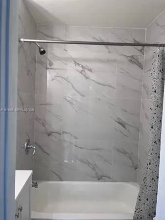 a bathroom with a shower and a bathtub