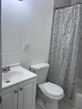a white toilet sitting next to a bathroom sink