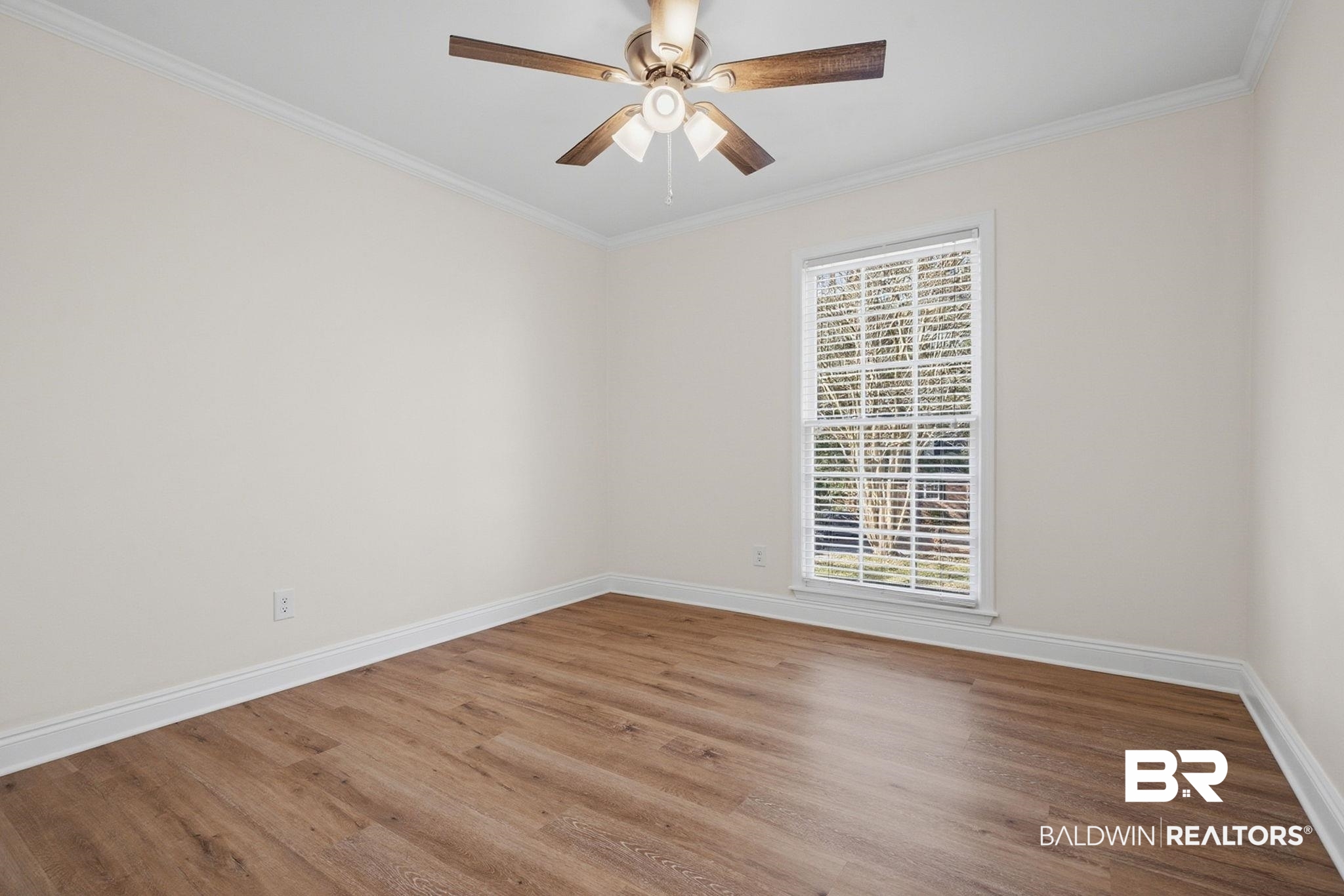 814 Nassau Drive Mobile, AL 36608 - Photo 20 of 44 Empty room with ornamental molding, wood finished floors, and a ceiling fan