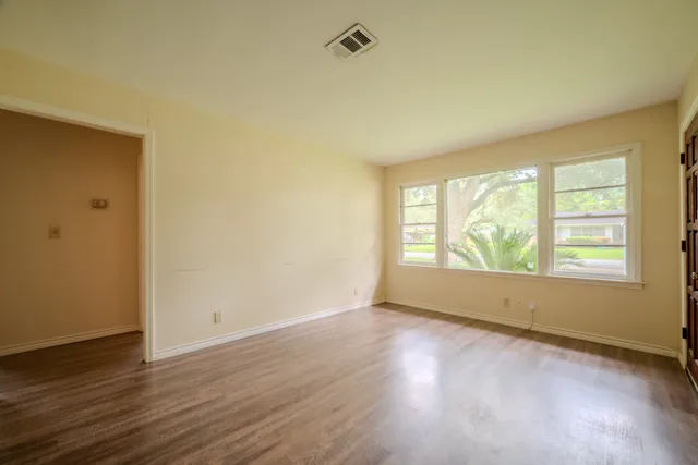 a kitchen with sink a refrigerator and wooden floor