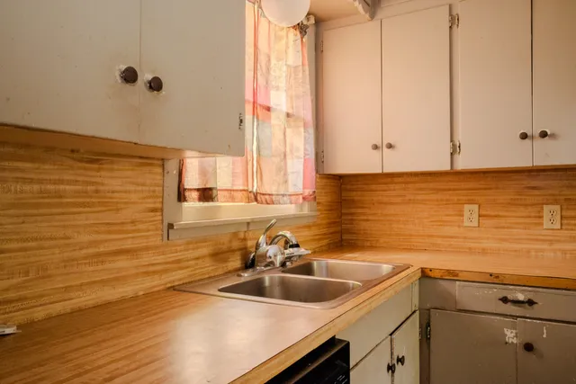 a view of a room with wooden floor