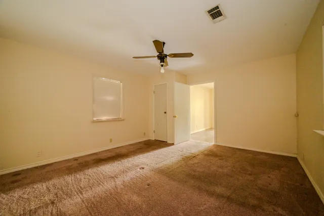 a view of an empty room and wooden floor