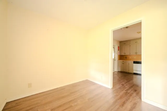 a view of a room with wooden floor