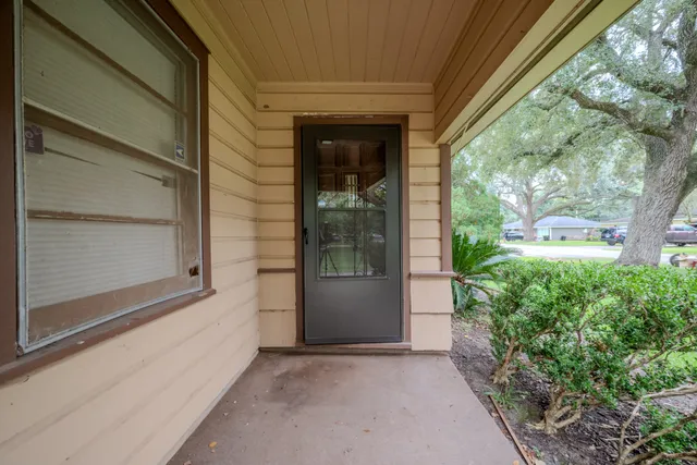 a view of a room with wooden floor and windows