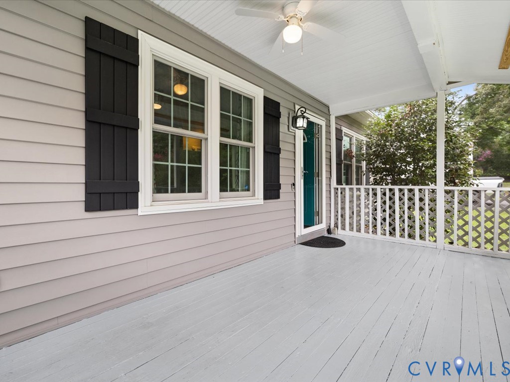 Covered front porch featuring light gray wood-fini