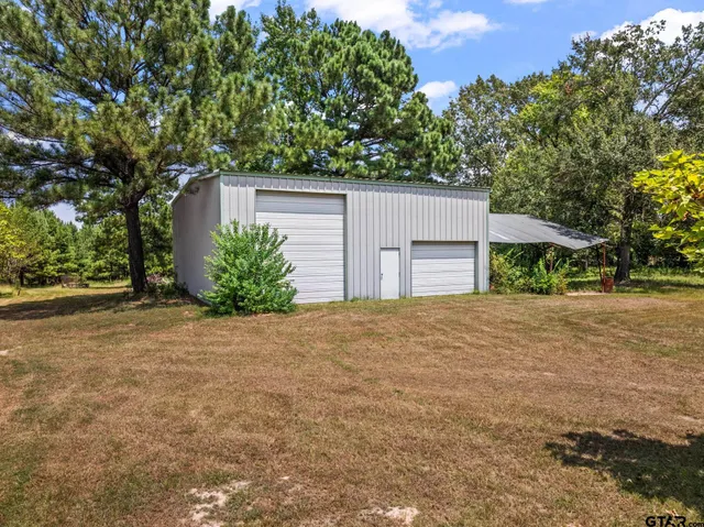 front view of a house with a yard and a garage