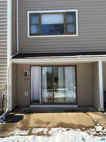 a view of a house with snow on the road