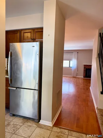 a very nice looking room with wooden floor and windows