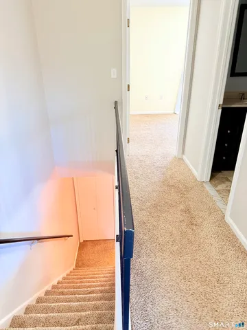 an empty room with a fan & a window