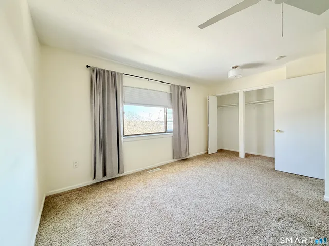 a bathroom with a double vanity sink toilet mirror and shower
