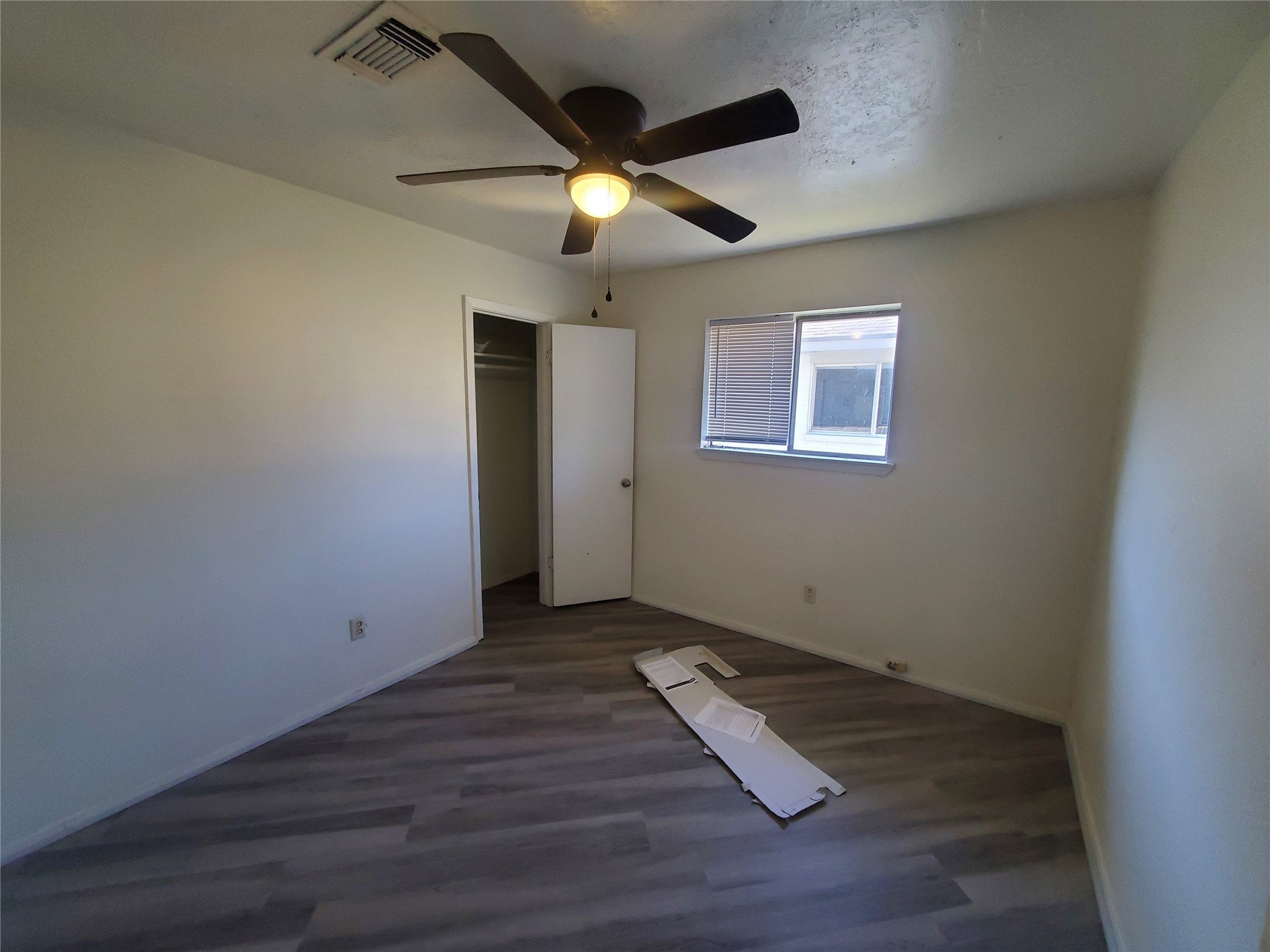 6518 Brookgate Drive Spring, TX 77373 - Photo 9 of 14 an empty room with wooden floor and ceiling fan
