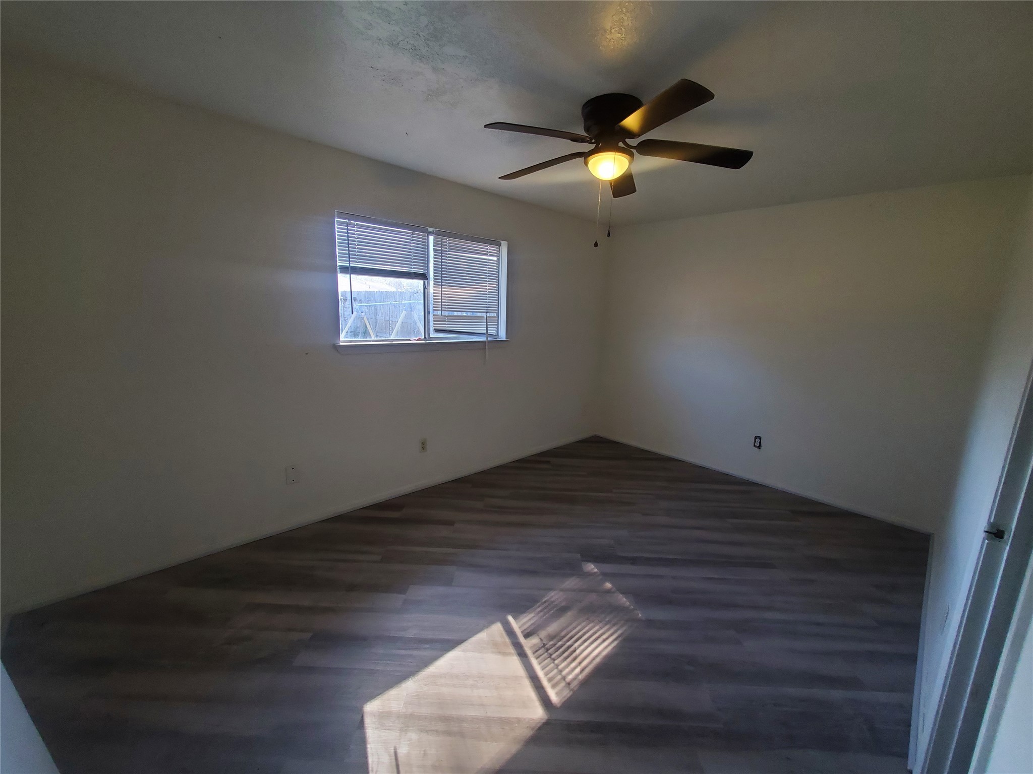 6518 Brookgate Drive Spring, TX 77373 - Photo 10 of 14 a view of an empty room with wooden floor and a window