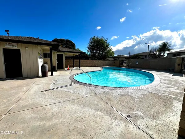 a view of a swimming pool with a yard