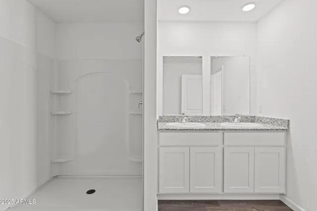 a bathroom with a granite countertop window and a shower
