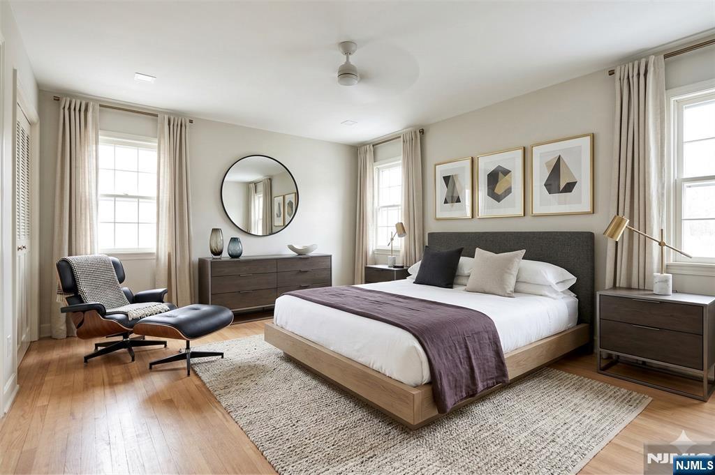 40 Hering Road Montvale, NJ 07645 - Photo 14 of 29 a spacious bedroom with a bed a table and chair