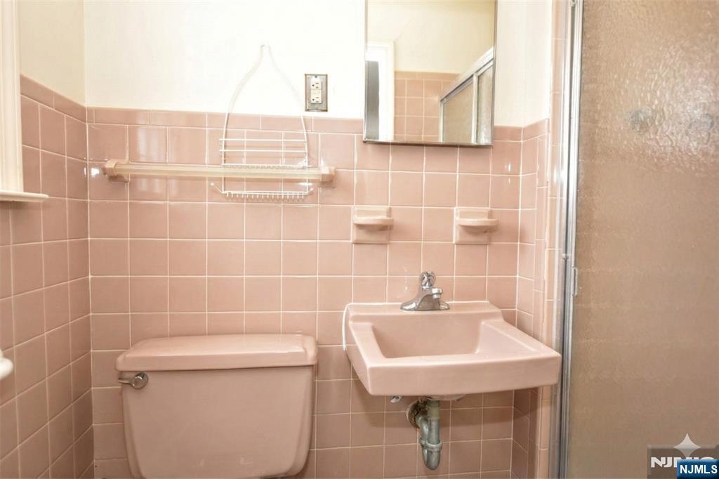 40 Hering Road Montvale, NJ 07645 - Photo 15 of 29 a bathroom with a sink a toilet and a mirror